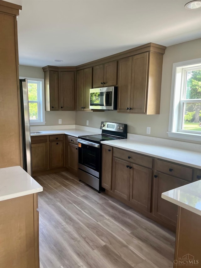 363 Don Ln, Delhi Twp, OH 45238 - kitchen with stainless steel appliances, light wood-type flooring, and light countertops