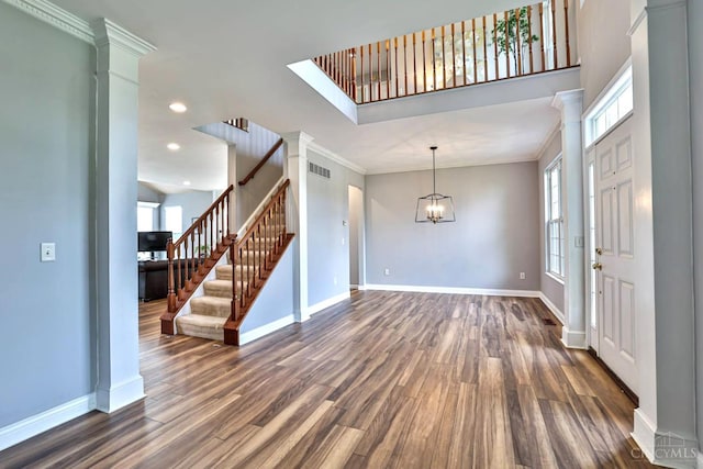 4623 Steeplechase Dr, Batavia Twp, OH 45103 - foyer entrance with decorative columns, dark wood finished floors, healthy amount of natural light, ornamental molding, and recessed lighting