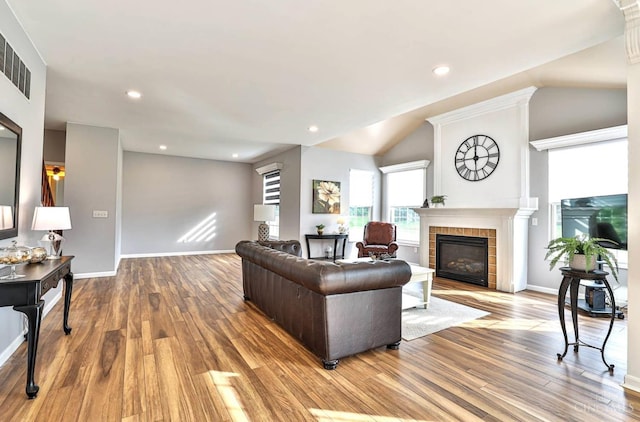 4623 Steeplechase Dr, Batavia Twp, OH 45103 - living area featuring a tile fireplace, wood finished floors, lofted ceiling, and recessed lighting