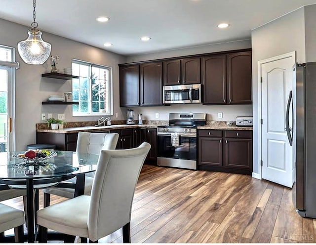 4623 Steeplechase Dr, Batavia Twp, OH 45103 - kitchen with appliances with stainless steel finishes, dark brown cabinetry, healthy amount of natural light, recessed lighting, and light wood finished floors