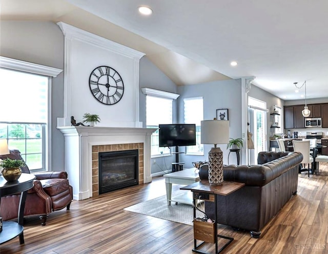 4623 Steeplechase Dr, Batavia Twp, OH 45103 - living room with vaulted ceiling, wood finished floors, a tiled fireplace, and recessed lighting