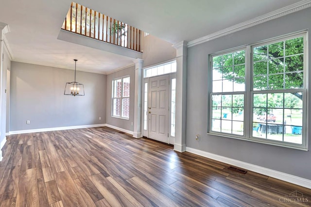 4623 Steeplechase Dr, Batavia Twp, OH 45103 - entrance foyer with crown molding, dark wood-style flooring, decorative columns, and a chandelier