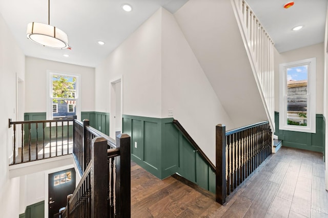 2241 Kemper Ln, Cincinnati, OH 45206 - stairs featuring a wainscoted wall, wood finished floors, a decorative wall, and recessed lighting