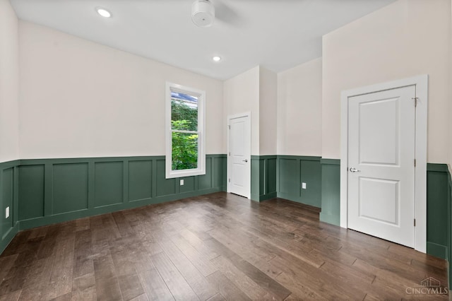 2241 Kemper Ln, Cincinnati, OH 45206 - empty room with wainscoting, wood finished floors, and a decorative wall