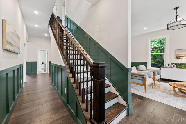 2241 Kemper Ln, Cincinnati, OH 45206 - stairway featuring wood finished floors, wainscoting, a decorative wall, and recessed lighting