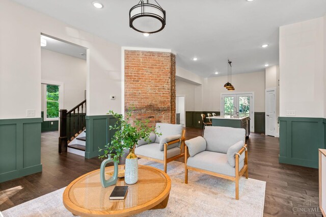 2241 Kemper Ln, Cincinnati, OH 45206 - living area featuring a decorative wall, stairway, dark wood finished floors, recessed lighting, and wainscoting