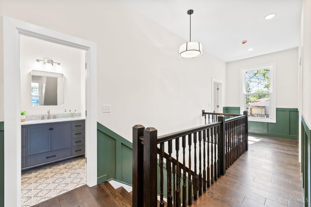 2241 Kemper Ln, Cincinnati, OH 45206 - hall with an upstairs landing, a wainscoted wall, and dark wood finished floors