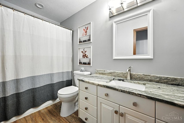 11545 Deer Trace Ln, Harrison Twp, OH 45030 - full bath with wood finished floors, vanity, a textured ceiling, and a shower with curtain
