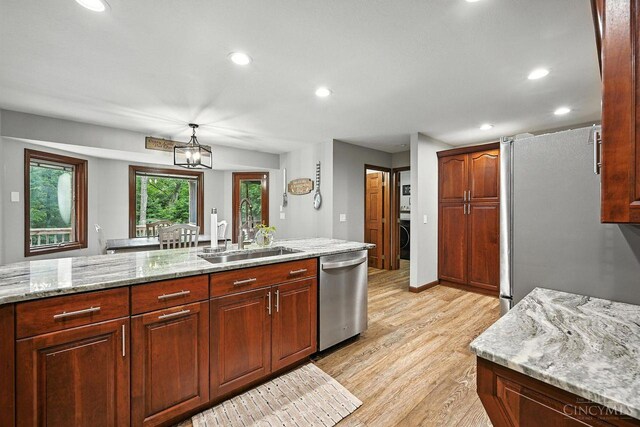 11545 Deer Trace Ln, Harrison Twp, OH 45030 - kitchen with appliances with stainless steel finishes, light wood-style flooring, recessed lighting, light stone countertops, and hanging light fixtures