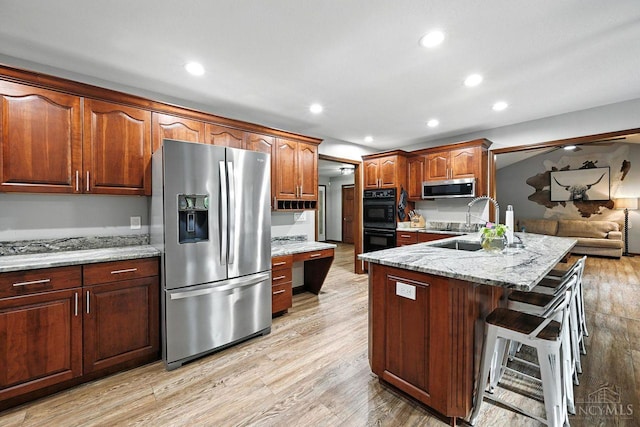 11545 Deer Trace Ln, Harrison Twp, OH 45030 - kitchen featuring stainless steel appliances, a peninsula, a breakfast bar area, recessed lighting, and light wood-type flooring