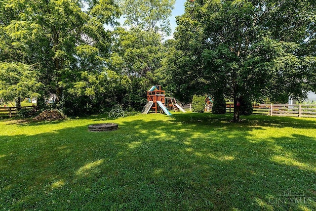 1165 Mcguffey Ln, Union Twp, OH 45103 - fenced backyard with a playground and an outdoor fire pit