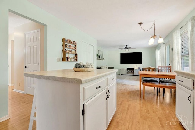 1165 Mcguffey Ln, Union Twp, OH 45103 - kitchen featuring a ceiling fan, light wood-style floors, white cabinets, and light countertops
