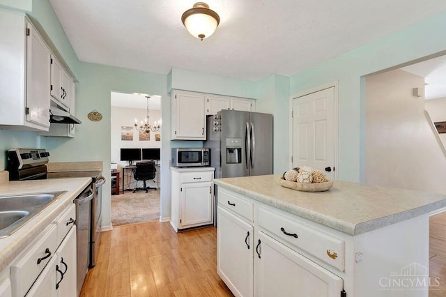 1165 Mcguffey Ln, Union Twp, OH 45103 - kitchen featuring appliances with stainless steel finishes, light wood-style floors, under cabinet range hood, and white cabinetry