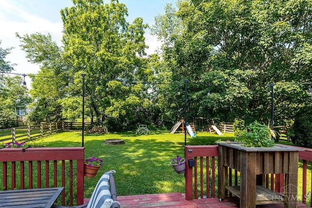 1165 Mcguffey Ln, Union Twp, OH 45103 - wooden terrace featuring an outdoor fire pit, a fenced backyard, and view of scattered trees