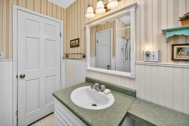 10410 Maria Ave, Springfield Twp, OH 45231 - full bathroom featuring wallpapered walls, wainscoting, vanity, a tile shower, and a chandelier