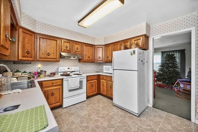 10410 Maria Ave, Springfield Twp, OH 45231 - kitchen with white appliances, under cabinet range hood, wallpapered walls, and brown cabinets
