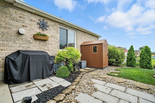 1751 Tatum Ln, Hamilton, OH 45013 - view of patio / terrace with a storage shed and a grill