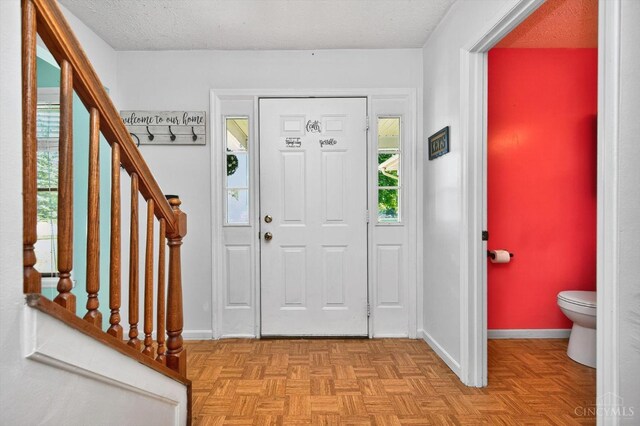 90 Lorelei Dr, Perry Twp, OH 45118 - entrance foyer featuring stairs and a textured ceiling