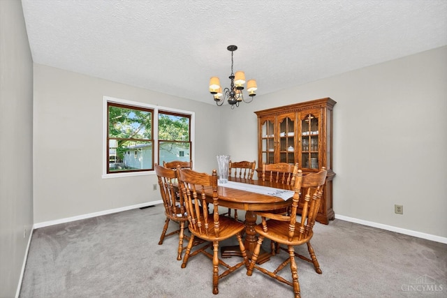 90 Lorelei Dr, Perry Twp, OH 45118 - carpeted dining area featuring a chandelier and a textured ceiling