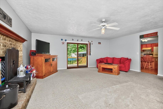 90 Lorelei Dr, Perry Twp, OH 45118 - living room featuring a textured ceiling, a fireplace, a ceiling fan, and carpet floors