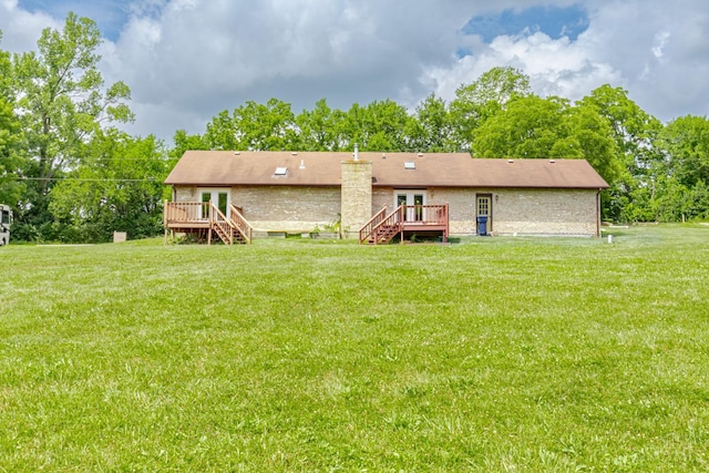 207 Valhalla Cv, Lakengren, OH 45320 - rear view of house with stairway, a deck, a yard, and view of scattered trees