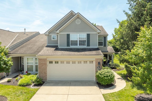 4247 Fieldsedge Dr, Mason, OH 45040 - view of front of home with driveway, brick siding, and roof with shingles