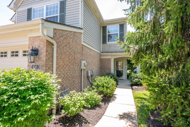4247 Fieldsedge Dr, Mason, OH 45040 - view of exterior entry with brick siding and a garage