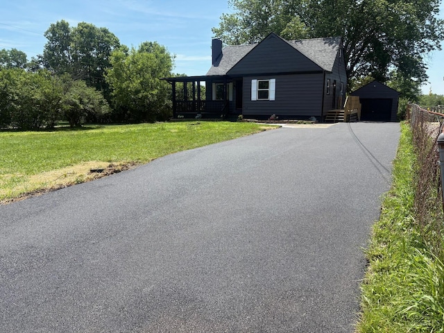 569 Beissinger Rd, Saint Clair Twp, OH 45013 - view of front of property with a detached garage, an outbuilding, driveway, a front yard, and a chimney