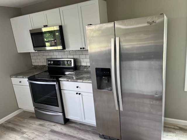 569 Beissinger Rd, Saint Clair Twp, OH 45013 - kitchen with stainless steel appliances, light wood finished floors, and white cabinetry