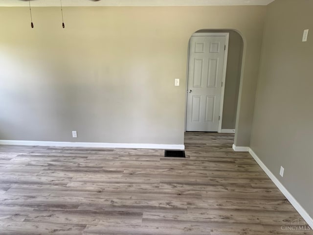 569 Beissinger Rd, Saint Clair Twp, OH 45013 - empty room featuring arched walkways and wood finished floors