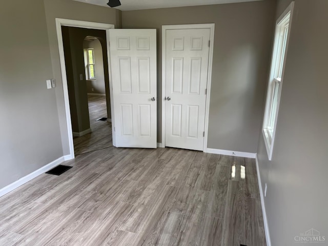 569 Beissinger Rd, Saint Clair Twp, OH 45013 - unfurnished bedroom featuring arched walkways and wood finished floors