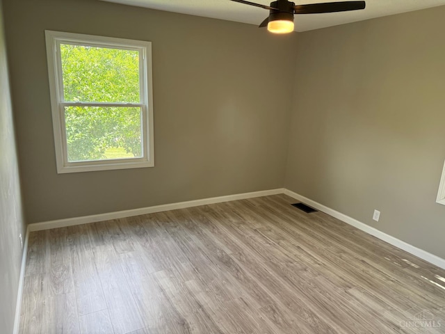 569 Beissinger Rd, Saint Clair Twp, OH 45013 - unfurnished room with light wood-style floors, healthy amount of natural light, and a ceiling fan