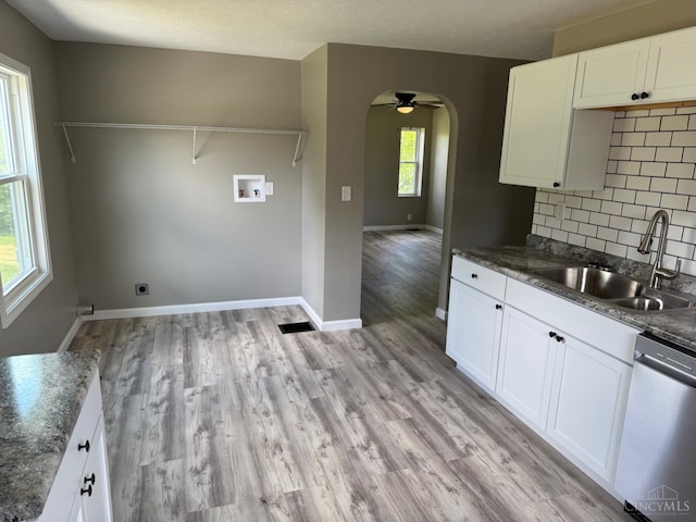 569 Beissinger Rd, Saint Clair Twp, OH 45013 - kitchen featuring stainless steel dishwasher, ceiling fan, decorative backsplash, light wood-style floors, and white cabinets