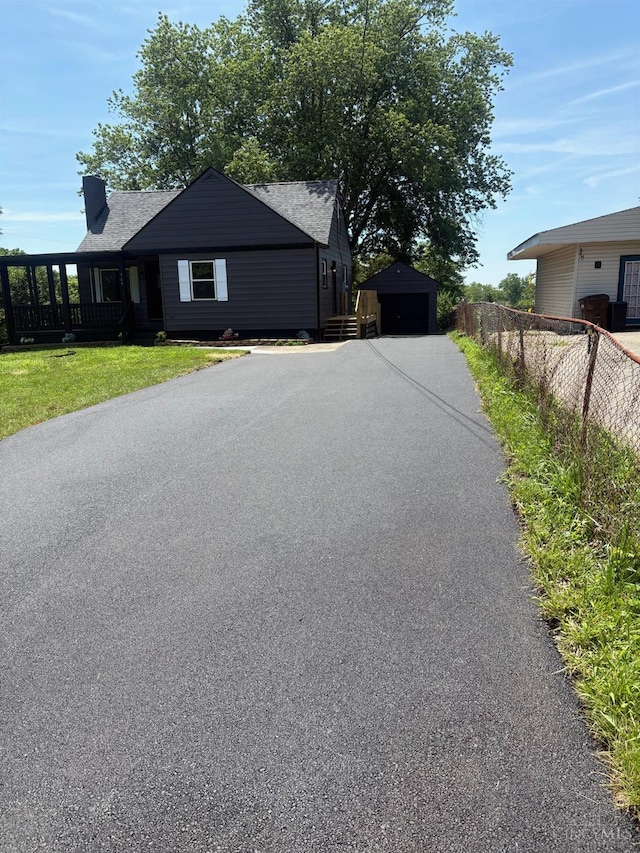 569 Beissinger Rd, Saint Clair Twp, OH 45013 - view of front of home featuring driveway, a garage, and an outbuilding