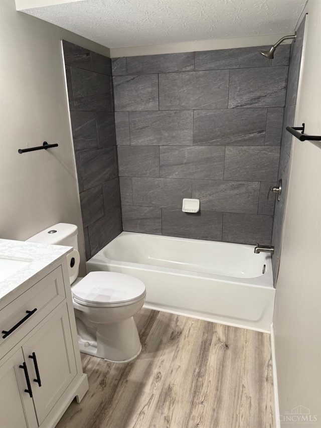 569 Beissinger Rd, Saint Clair Twp, OH 45013 - full bathroom featuring wood finished floors, vanity, a textured ceiling, and bathtub / shower combination