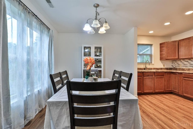 2465 Wilson Ave, Cincinnati, OH 45231 - dining room with light wood-style flooring, a chandelier, and recessed lighting