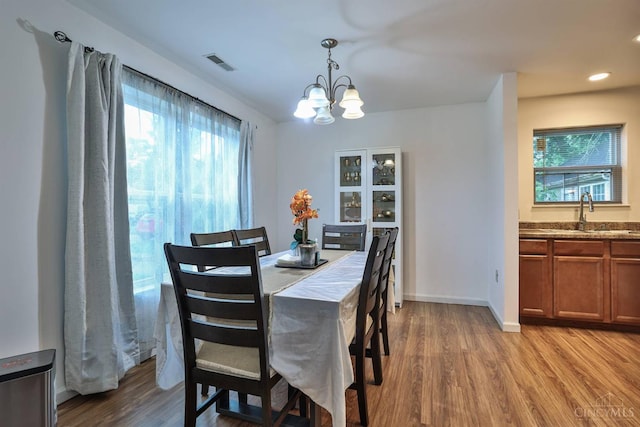 2465 Wilson Ave, Cincinnati, OH 45231 - dining space featuring wood finished floors, a chandelier, healthy amount of natural light, and recessed lighting