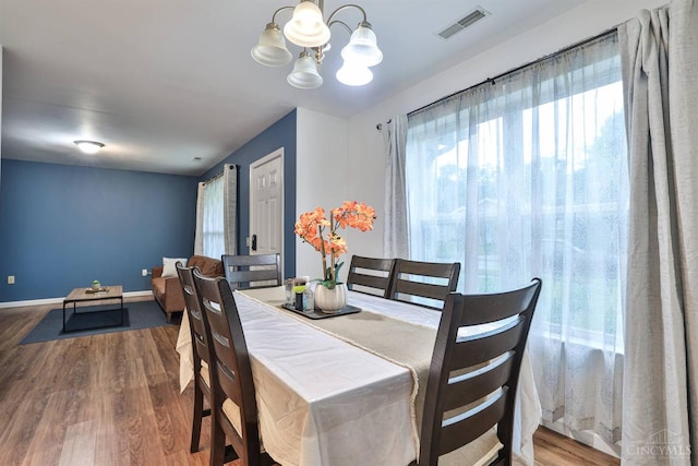 2465 Wilson Ave, Cincinnati, OH 45231 - dining area featuring wood finished floors and a chandelier