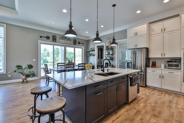 7948 Red Fox Trl, Hamilton Twp, OH 45152 - kitchen with stainless steel appliances, white cabinetry, recessed lighting, light wood-type flooring, and a breakfast bar area