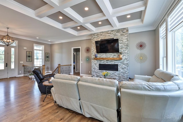 7948 Red Fox Trl, Hamilton Twp, OH 45152 - living room featuring coffered ceiling, light wood-type flooring, beamed ceiling, a chandelier, and a stone fireplace