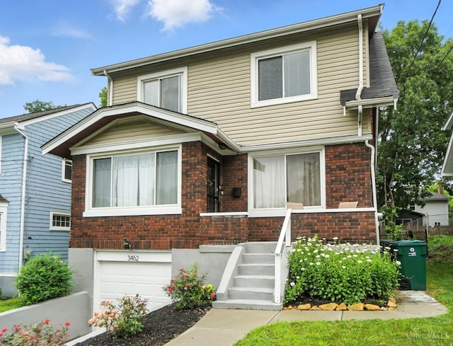 3462 Wabash Ave, Cincinnati, OH 45207 - view of front of house with an attached garage and brick siding