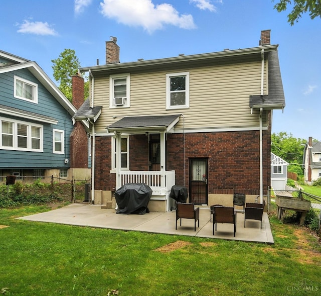 3462 Wabash Ave, Cincinnati, OH 45207 - back of property with a chimney, a patio, brick siding, and cooling unit
