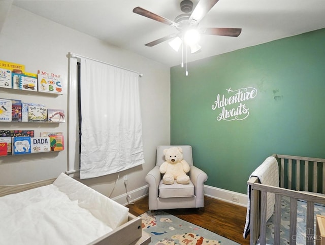 3462 Wabash Ave, Cincinnati, OH 45207 - bedroom with a nursery area, wood finished floors, and a ceiling fan