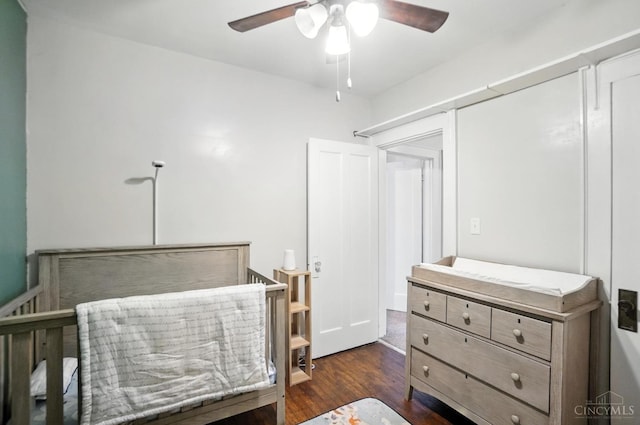 3462 Wabash Ave, Cincinnati, OH 45207 - bedroom with dark wood-style flooring, ceiling fan, and a crib