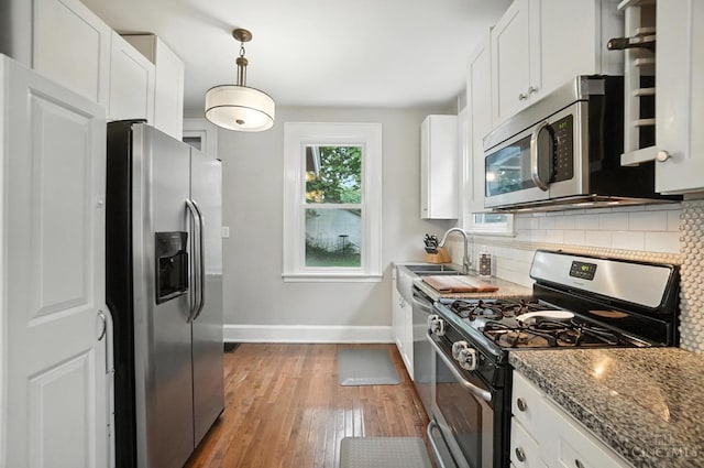 3462 Wabash Ave, Cincinnati, OH 45207 - kitchen featuring stainless steel appliances, backsplash, hardwood / wood-style flooring, and white cabinetry