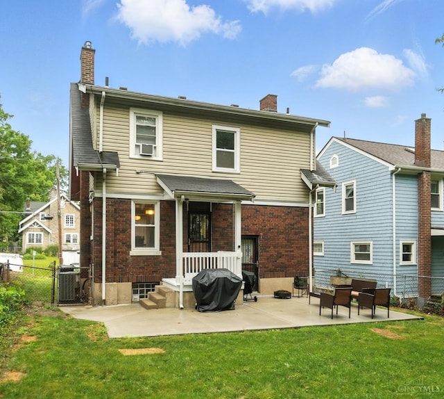 3462 Wabash Ave, Cincinnati, OH 45207 - back of property with a chimney, a patio area, and brick siding
