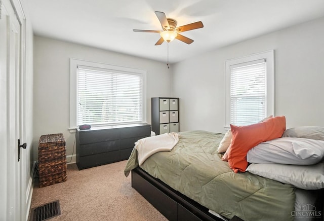 3462 Wabash Ave, Cincinnati, OH 45207 - bedroom with multiple windows, carpet, and a ceiling fan
