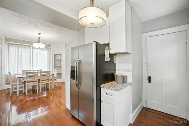 3462 Wabash Ave, Cincinnati, OH 45207 - kitchen with stainless steel refrigerator with ice dispenser, hardwood / wood-style floors, white cabinetry, and tasteful backsplash