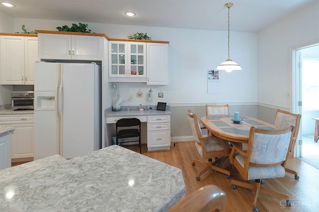 3893 Jocelyn Dr, Fairfield Twp, OH 45011 - kitchen featuring white fridge with ice dispenser, light wood-style floors, glass insert cabinets, white cabinetry, and recessed lighting