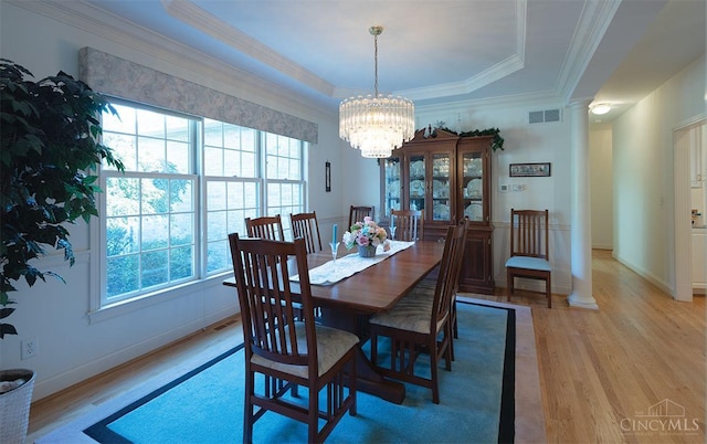 3893 Jocelyn Dr, Fairfield Twp, OH 45011 - dining area with light wood-style flooring, healthy amount of natural light, a raised ceiling, a chandelier, and ornamental molding